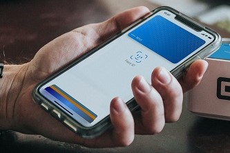 A person ready to pay at a restaurant using a mobile wallet application in their cellphone