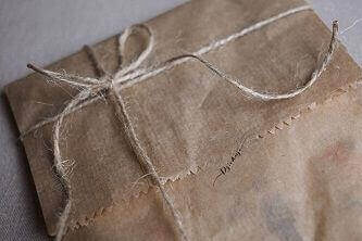 A light brown package tied with a string