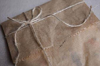 A light brown package tied with a string