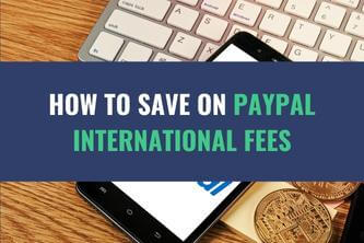 An image of a table with a laptop, mobile phone and coins placed on it with the title - How to Save on PayPal International Fees
