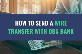 An image of a person working on a laptop computer with the title - How to Send a Wire Transfer with DBS Bank