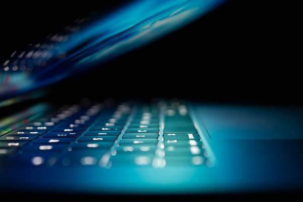 Closeup photo of turned-on blue and white laptop computer photo