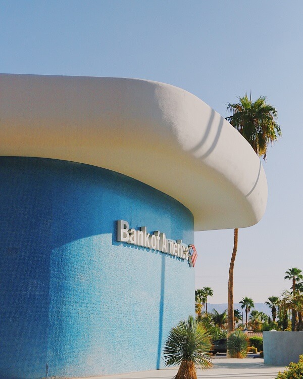 A building with palm trees in the background and a Bank of America logo on it