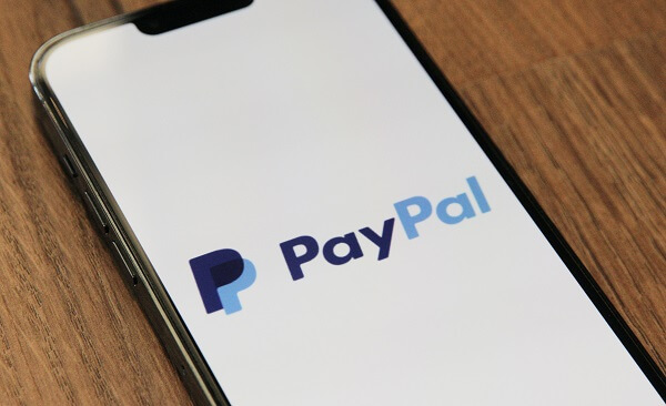 An image of a cell phone with the PayPal mobile app loaded on it
