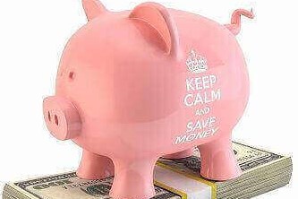 A piggy bank placed on a bundle of currency notes