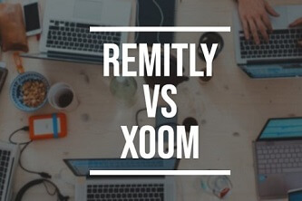 Remitly vs Xoom printed on a background with laptops and phones on a table