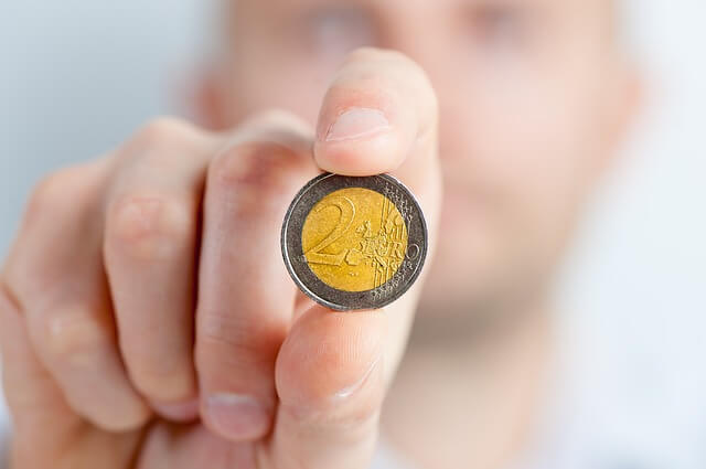 A person holding a coin in their hand