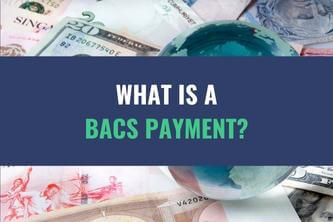 An image of an assortment of currency bills with the title - What Is A BACS Payment?