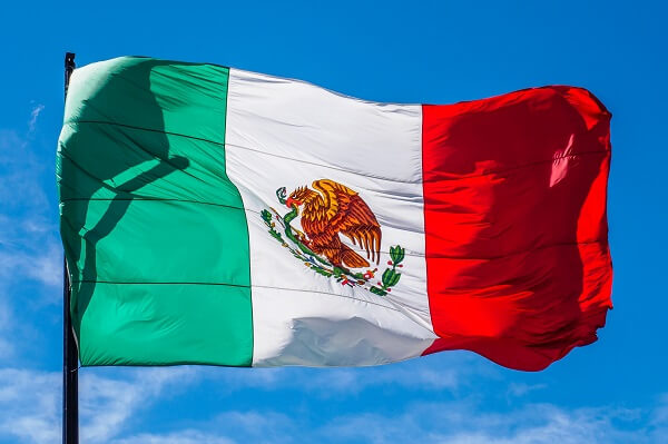 An image of the flag of Mexico waving in the air