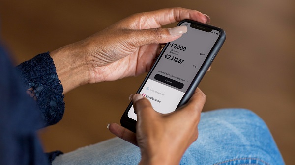A person using the Atlantic Money iOS app to send money overseas
